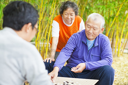 老年人玩传统的中国棋盘游戏 Go公园幸福老年女士象棋农村友谊祖母享受男人图片