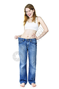 体重减肥后穿着牛仔裤的快乐女孩女性损失裤子运动腰部尺寸青少年微笑白色饮食图片