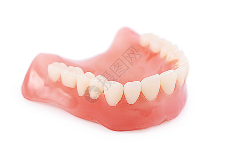 白色背景上隔离的一组假牙塑料生产假体牙医保健实验室抛光微笑医生假肢图片