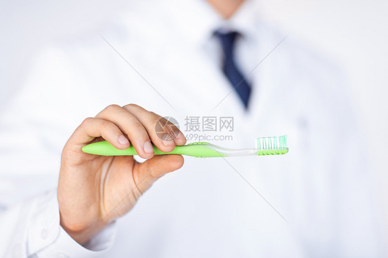 持有牙刷的牙医或口腔医生订金疾病牙齿治疗男人教育口腔科美白牙科专家图片