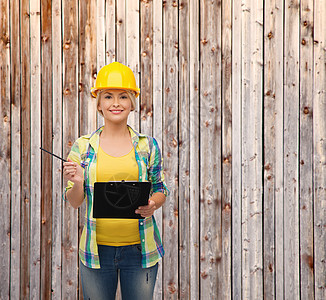 带着剪贴板戴头盔的笑着女人职业工具建筑成人维修建设者笔记安全承包商工人图片