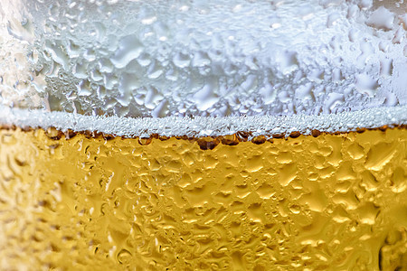 冰啤酒杯气泡气体酒精运动啤酒泡沫黄色苏打酒吧灯光背景图片