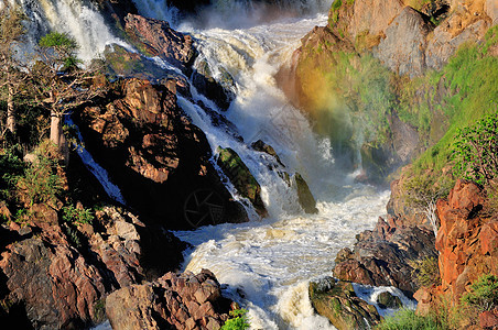 安哥拉和纳米比亚边界的Epupa瀑布悬崖苦烯戏剧性洪水急流红色岩石彩虹科兰巨石图片
