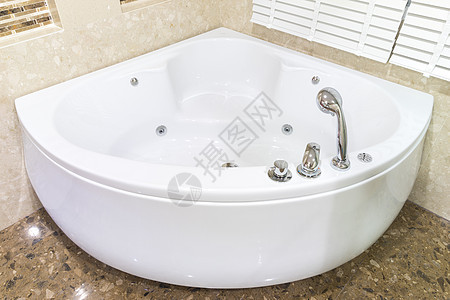 按摩浴缸在浴室的角落白色水力龙头漩涡喷射温泉洗澡棕色溪流马赛克图片