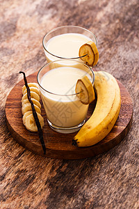 牛奶香蕉美味的香蕉奶昔奶制品玻璃茶点甜点水果营养桌子香草假期饮料背景