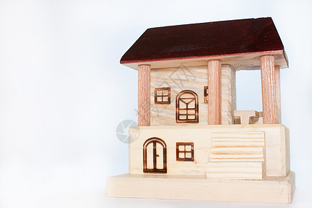 白色背景的木制房子木头市场玩具财产娃娃孩子们小屋住宅红色绿色图片