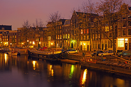 晚上在荷兰阿姆斯特丹市风景运输特丹城市房子日落建筑学街道自行车历史建筑图片