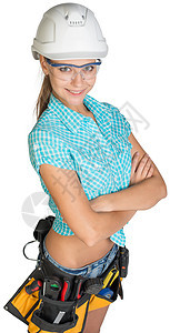 身戴硬帽 工具带和防护眼镜的妇女卷尺胶带工作服女性腰带双手工作室绝缘层面高角度图片