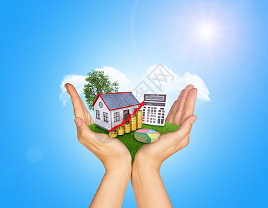 太阳能房子手握着绿草和房屋在地面上 本底是站立的树和云太阳能板太阳山墙图表树叶房子饼形水管绿色棕榈背景