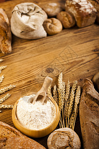 面粉桌面传统烤面包 天然色彩多彩的音调小麦农业篮子向日葵面粉粮食饮食早餐大麦亚麻背景