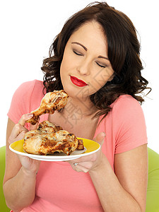 女孩吃冷煮鸡腿节食黑发成人低脂肪食物女士摄影冒充控制白色图片