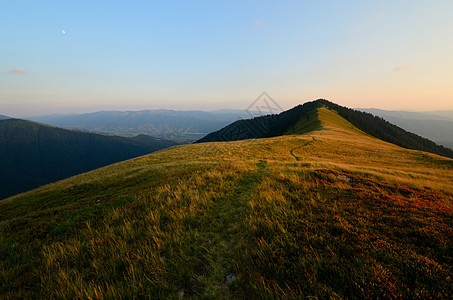 山坡日落爬坡草地山脉森林岩石土地太阳植物天空季节图片