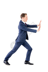 一个商务人士推着东西的东西套装男人挣扎双手男性领带夹克商务重量人士背景图片