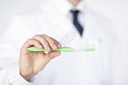 持有牙刷的牙医或口腔医生男性订金打扫男人教学口腔科专家护理教育牙科图片