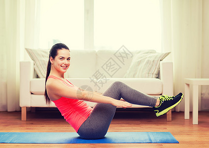 在家地板上做运动的微笑女孩肌肉运动装腹部有氧运动训练房间运动员女性耐力拉丁图片