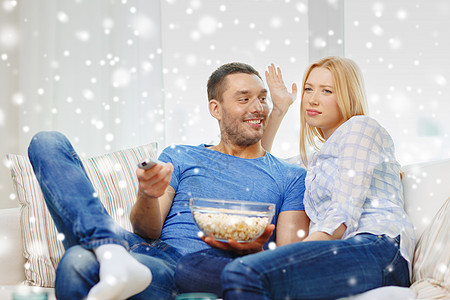 在家看着电视的情侣笑着看电视控制房间沙发小吃按钮女士观众夫妻恋人电影图片
