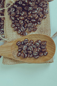 麻袋表面的咖啡豆和木勺 Filter 效果雷特解雇勺子食物棕色粮食木头麻布美食咖啡图片