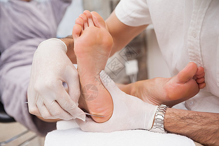 使用手术刀的沙龙工人修脚美甲按摩修脚师工作指甲足部中心死皮奢华图片