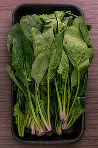 绿色菠菜收成美食植物沙拉木头盘子生产草本植物木板营养图片
