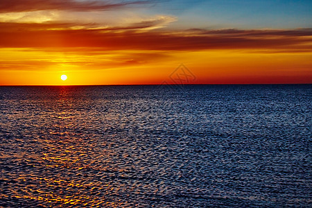 日落在海洋上海岸阳光海浪晴天反射天空地平线橙子天气太阳图片