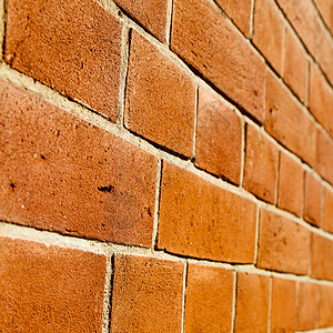 大理石砖在隆登 的抽象纹理 蚂蚁墙和废墟建筑建造建筑学棕褐色橙子大理石古董风化材料石头背景