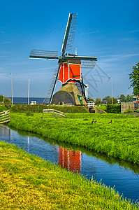 荷兰或荷兰的Kinderdijk风车和水渠活力磨坊运河小孩环境力量反射旅行遗产场地图片