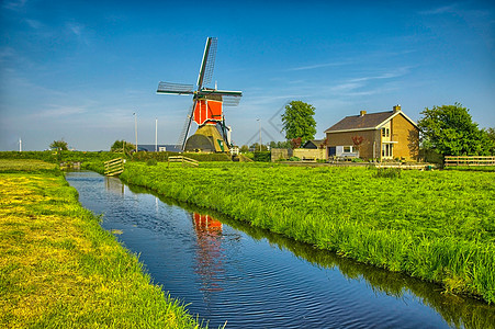 荷兰或荷兰的Kinderdijk风车和水渠场地反射风景小孩历史农村天空建筑学遗产历史性图片