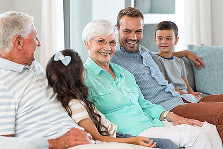幸福的家庭坐在沙发上混血老年亲密感女性听力男人男生公寓休闲喜悦图片
