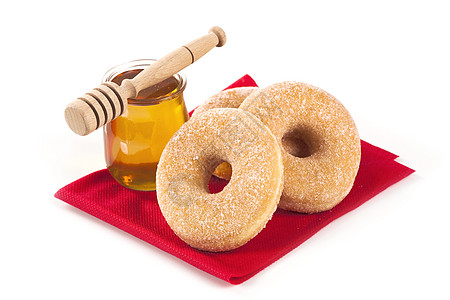 甜甜圈和蜂蜜餐巾纸糕点小吃油炸玻璃早餐育肥静物食物红色图片