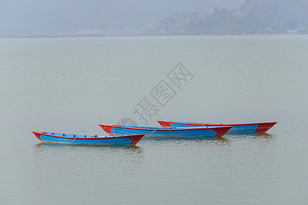 波克拉Phewa湖的三艘蓝船运输木头工艺旅游蓝色独木舟红色旅行图片