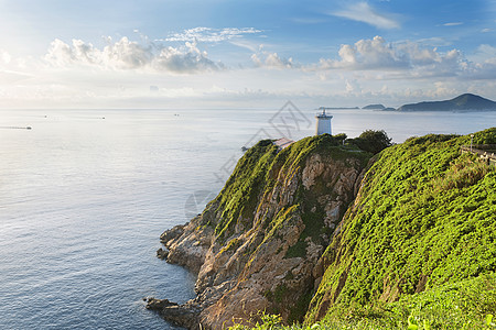 日出时香港灯塔紫色导航海洋海景地标地平线戏剧性阳光爬坡日落图片