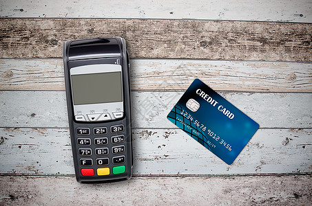 木制背景付款终端和信用卡支付站和背景图片