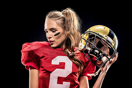 女足球运动员佩戴头盔的装扮胜利运动装扇子行动活力橄榄球玩家风险冒充联盟图片