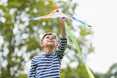 男孩在公园里拿着风筝享受微笑活动晴天乐趣农村男生俏皮假期快乐图片