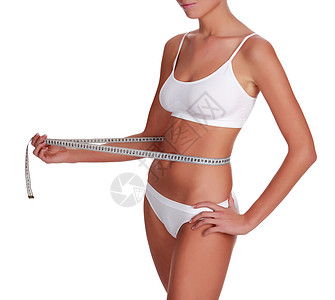 女性用腰部测量她的腰部 与白种背景隔绝皮肤饮食女孩内衣腰围组织腹部损失肥胖营养图片