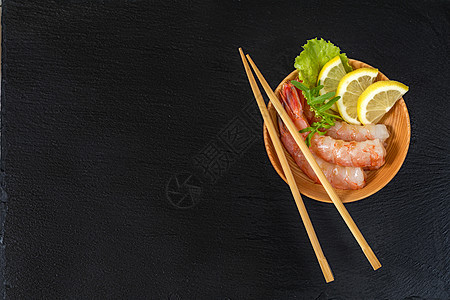 木棍子木板上的虾头对虾台面盘子石头饮食专业柠檬餐厅筷子美食背景图片