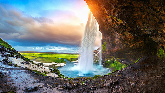 日落时的塞尔杰兰斯福斯瀑布 冰岛美丽的瀑布溪流石头地标天空力量太阳运动旅游彩虹荒野图片