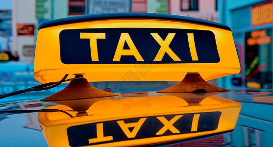 城市出租车车顶上的Lit Lit计程车牌司机路灯服务商业照明车辆飞机场汽车点燃街道图片