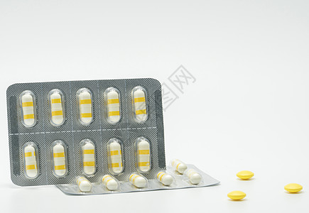 在白色背景的消炎药胶囊药片 医药包装行业 药房背景图片
