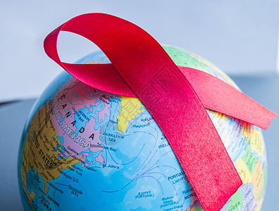 12月1日世界艾滋病日 以红色丝带环绕世界免疫斗争缺陷感染活动庆典团结疾病地球药品图片