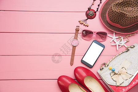 妇女的衣服 放在粉红色木制地板上图片