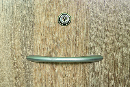 带一个钥匙孔的棕色木壁柜抽屉背景图片