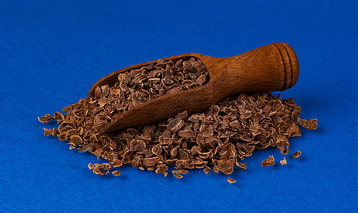 以蓝色背景隔绝的木制独木勺中巧克力格化 特首图片