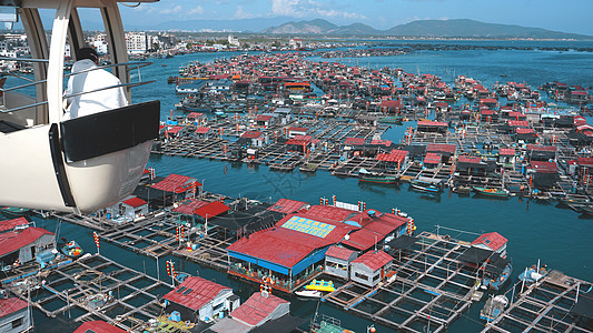 中国渔民村Linshui 海南海岸钓鱼建筑环礁码头渔业天空港口房子海滩图片