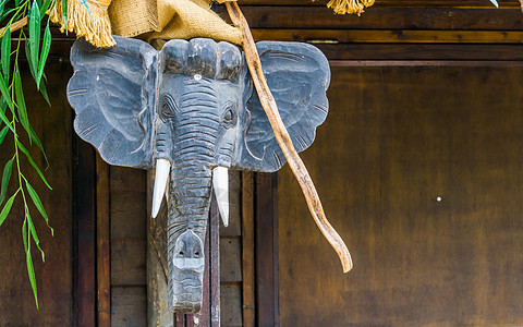 大象头雕塑挂在木杆上 非洲传统的家庭装饰品图片