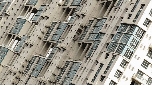 高层建筑中的抽象图案几何形状 现代摩天大楼中的建筑设计 倾斜的图像 特写 背景摄影图片