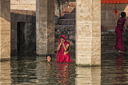 身份不明的印度妇女朝圣者在Ga圣地河洗澡图片