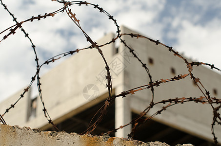 在被遗弃的Bui的背景下 生锈 刺铁丝网栅栏建筑天空监狱蓝天蓝色安全图片