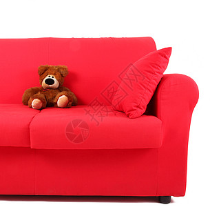 白色背景的红沙发上的木偶傀儡图片
