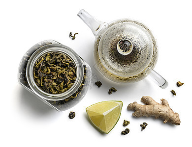 绿色茶叶 茶壶 姜和石灰在白色背景上图片